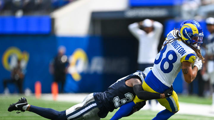 Aug 11, 2024; Inglewood, California, USA; Dallas Cowboys running back Snoop Conner (32) tackles Los Angeles Rams wide receiver Jordan Whittington (88) during the second quarter at SoFi Stadium. Mandatory Credit: Jonathan Hui-USA TODAY Sports