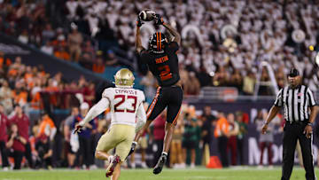 Oct 26, 2024; Miami Gardens, Florida, USA; Miami Hurricanes wide receiver Isaiah Horton (2) cst chef the football against Florida State Seminoles defensive back Fentrell Cypress II (23) during the second quarter at Hard Rock Stadium. Mandatory Credit: Sam Navarro-Imagn Images