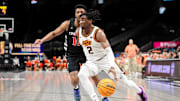 Mar 11, 2025; Kansas City, MO, USA; Oklahoma State Cowboys guard Arturo Dean (2) drives to the basket around Cincinnati Bearcats guard Josh Reed (10) during the first half at T-Mobile Center. Mandatory Credit: William Purnell-Imagn Images