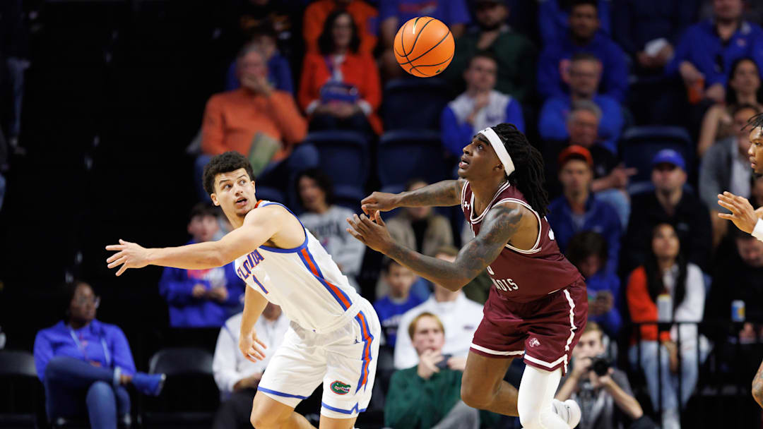 Nov 22, 2024; Gainesville, Florida, USA; Florida Gators guard Walter Clayton Jr. (1) and Southern Illinois Salukis guard Kennard Davis Jr. (30) battle for a loose ball during the second half at Exactech Arena at the Stephen C. O'Connell Center. Mandatory Credit: Matt Pendleton-Imagn Images