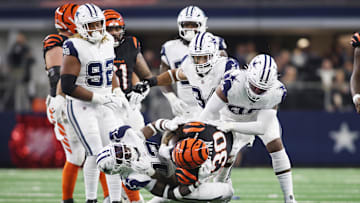 Dec 9, 2024; Arlington, Texas, USA; Cincinnati Bengals running back Chase Brown (30) is tackled by Dallas Cowboys linebacker DeMarvion Overshown (13) in the second quarter  at AT&T Stadium. Mandatory Credit: Tim Heitman-Imagn Images