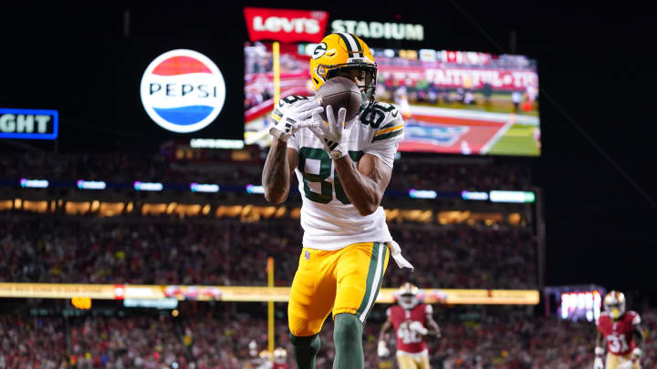 Packers receiver Bo Melton scores a touchdown vs. the 49ers in the playoffs.