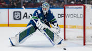 Mar 15, 2025; Vancouver, British Columbia, CAN; Vancouver Canucks goalie Arturs Silovs (31) handles the puck against the Chicago Blackhawks in the second period at Rogers Arena. Mandatory Credit: Bob Frid-Imagn Images