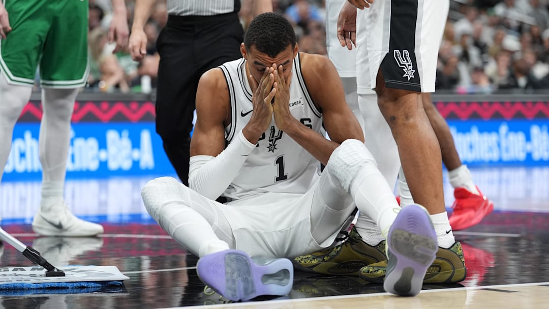 Mar 10, 2026; San Antonio, Texas, USA; San Antonio Spurs forward Victor Wembanyama (1) sits on the court after getting fouled against the Boston Celtics during the first half at Frost Bank Center. Mandatory Credit: Daniel Dunn-Imagn Images