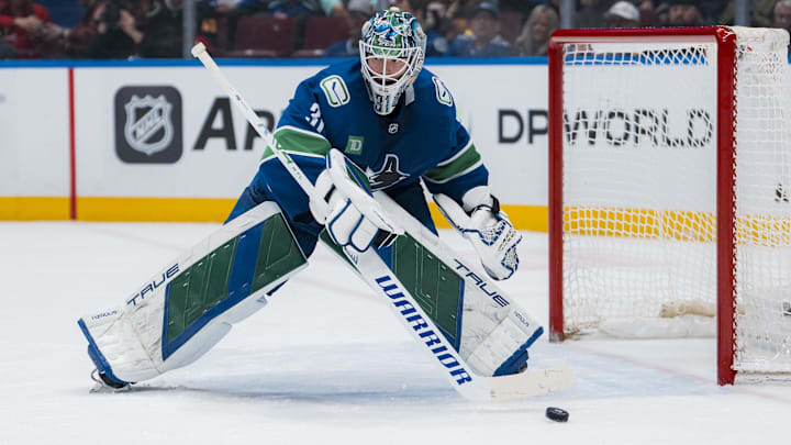 Mar 15, 2025; Vancouver, British Columbia, CAN; Vancouver Canucks goalie Arturs Silovs (31) handles the puck against the Chicago Blackhawks in the second period at Rogers Arena. Mandatory Credit: Bob Frid-Imagn Images