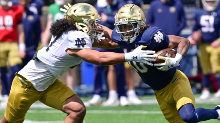 Apr 20, 2024; Notre Dame, IN, USA; Notre Dame Fighting Irish wide receiver Kris Mitchell (10) carries the ball as linebacker Kyngstonn Viliamu-Asa (27) attempts to tackle in the Blue-Gold Game at Notre Dame Stadium.