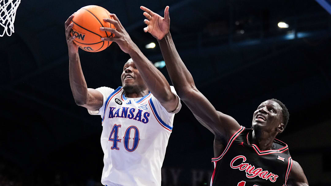 Feb 23, 2026; Lawrence, Kansas, USA; Kansas Jayhawks forward Flory Bidunga (40) rebounds as Houston Cougars forward Kalifa Sakho (14) defends during the first half of the game at Allen Fieldhouse. Mandatory Credit: Denny Medley-Imagn Images Feb 23, 2026; Lawrence, Kansas, USA; Kansas Jayhawks forward Flory Bidunga (40) rebounds as Houston Cougars forward Kalifa Sakho (14) defends during the first half of the game at Allen Fieldhouse. Mandatory Credit: Denny Medley-Imagn Images