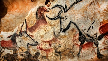 An exact replica of a cave painting in Lascaux showing a bison and aurochs facing each other, along with small horses and deer.