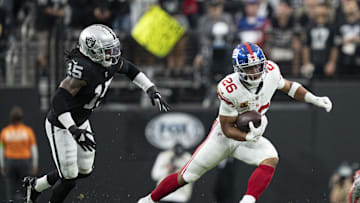 November 5, 2023; Paradise, Nevada, USA; New York Giants running back Saquon Barkley (26) runs the football against Las Vegas Raiders linebacker Jaylon Smith (15) during the first quarter at Allegiant Stadium. Mandatory Credit: Kyle Terada-Imagn Images