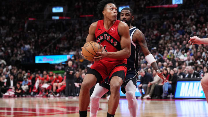 Feb 28, 2024; Toronto, Ontario, CAN; Toronto Raptors forward Scottie Barnes (4) controls the ball as Dallas Mavericks guard Kyrie Irving (11) tries to defend during the fourth quarter at Scotiabank Arena. Mandatory Credit: Nick Turchiaro-USA TODAY Sports