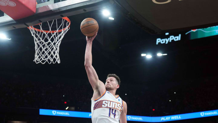 Mar 20, 2024; Phoenix, Arizona, USA; Phoenix Suns forward Drew Eubanks (14) dunks over Philadelphia 76ers forward Paul Reed (44) during the first half at Footprint Center. Mandatory Credit: Joe Camporeale-USA TODAY Sports