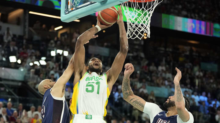 Aug 6, 2024; Paris, France; Brazil power forward Bruno Caboclo (51) shoots against United States guard Derrick White (8) and centre Anthony Davis (14) in the second half in a men’s basketball quarterfinal game during the Paris 2024 Olympic Summer Games at Accor Arena. Mandatory Credit: Kyle Terada-USA TODAY Sports