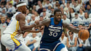 Minnesota Timberwolves forward Julius Randle dribbles the ball past Golden State Warriors forward Jimmy Butler III in the first half during Game 2 of their Western Conference semifinal at Target Center in Minneapolis on May 8, 2025.