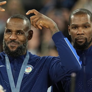 Aug 10, 2024; Paris, France; United States guard LeBron James (6) celebrates with the gold medal after the game against France in the men's basketball gold medal game during the Paris 2024 Olympic Summer Games at Accor Arena. Mandatory Credit: Kyle Terada-Imagn Images