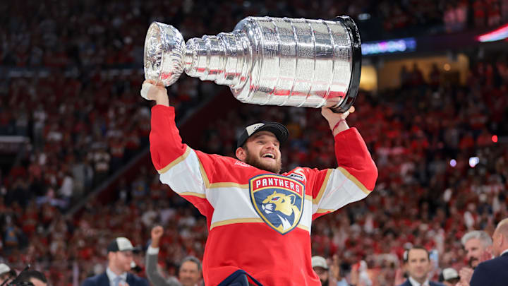 Jun 17, 2025; Sunrise, Florida, USA; Florida Panthers center Aleksander Barkov (16) hoists the Stanley Cup after winning game six of the 2025 Stanley Cup Final against the Edmonton Oilers at Amerant Bank Arena. Mandatory Credit: Sam Navarro-Imagn Images
