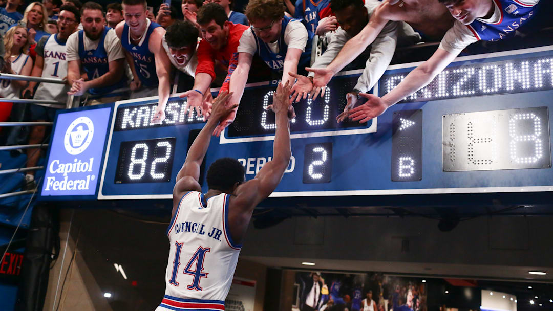 Kansas Jayhawks guard Melvin Council Jr. (14) slaps hands with fans after defeating Arizona Wildcats 82-78 in the game inside Allen Fieldhouse on Feb. 9, 2026.