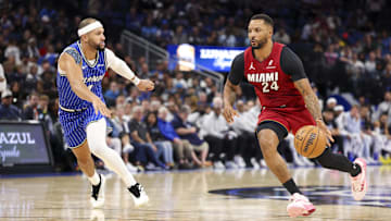 Dec 5, 2025; Orlando, Florida, USA; Miami Heat guard Norman Powell (24) drives to the basket past Orlando Magic guard Jalen Suggs (4) in the second quarter at Kia Center. Mandatory Credit: Nathan Ray Seebeck-Imagn Images