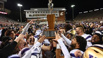 Nov 26, 2022; Pullman, Washington, USA; Washington Huskies hold the Apple Cup trophy after a game against the Washington State Cougars at Gesa Field at Martin Stadium. Mandatory Credit: James Snook-USA TODAY Sports