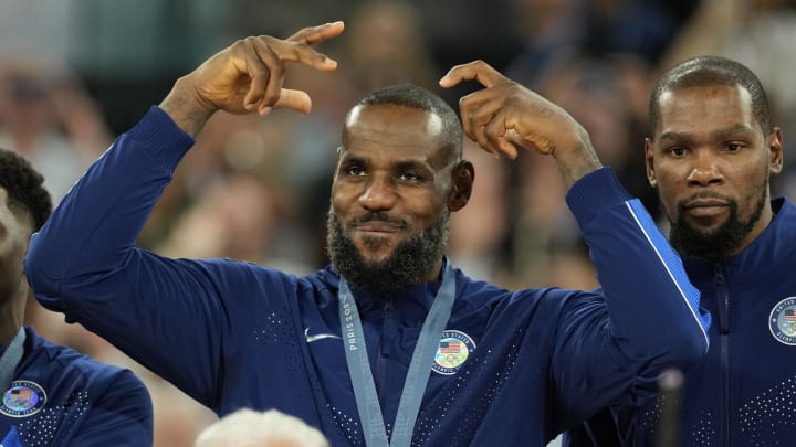 Aug 10, 2024; Paris, France; United States guard LeBron James (6) celebrates with the gold medal after the game against France in the men's basketball gold medal game during the Paris 2024 Olympic Summer Games at Accor Arena. Mandatory Credit: Kyle Terada-USA TODAY Sports