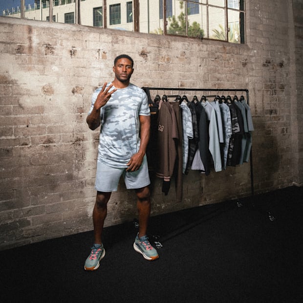 Reggie Bush stands next to his golf apparel.