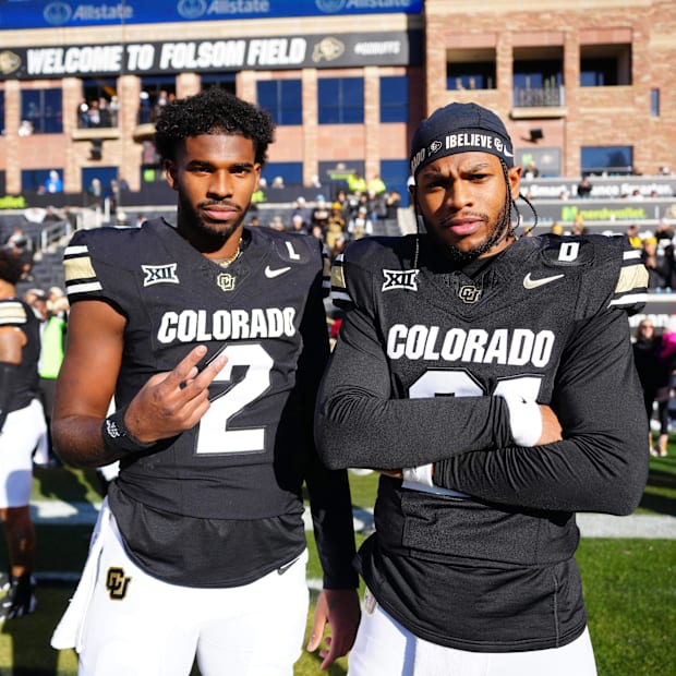 Nov 29, 2024; Boulder, Colorado, USA; Colorado Buffaloes quarterback Shedeur Sanders (2) and safety Shilo Sanders (21) pose f