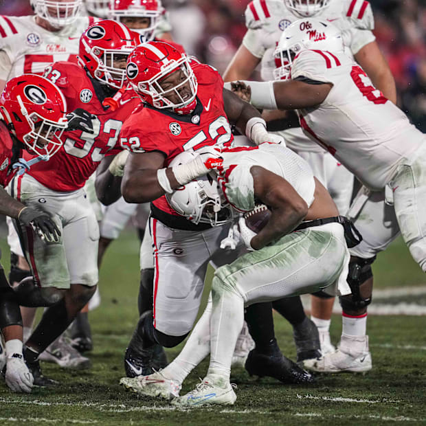 Georgia Bulldogs defensive lineman Christen Miller tackles Mississippi Rebels running back Quinshon Judkins 