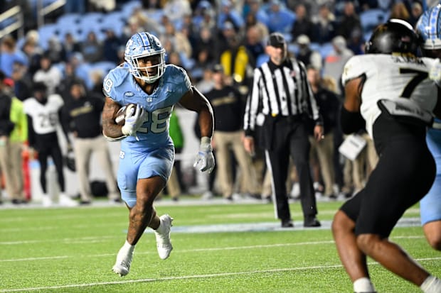 North Carolina Tar Heels running back Omarion Hampton runs against Wake Forest Demon Deacons defensive back Evan Slocum.