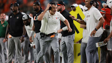 Sep 13, 2025; Miami Gardens, Florida, USA; Miami Hurricanes head coach Mario Cristobal runs on the sideline against the South Florida Bulls during the fourth quarter  at Hard Rock Stadium. Mandatory Credit: Sam Navarro-Imagn Images