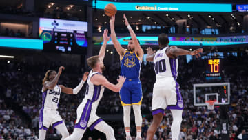 Apr 16, 2024; Sacramento, California, USA; Golden State Warriors guard Klay Thompson (11) shoots over Sacramento Kings guard Keon Ellis (23), forward Domantas Sabonis (10) and forward Harrison Barnes (40) in the second quarter during a play-in game of the 2024 NBA playoffs at the Golden 1 Center. Mandatory Credit: Cary Edmondson-USA TODAY Sports