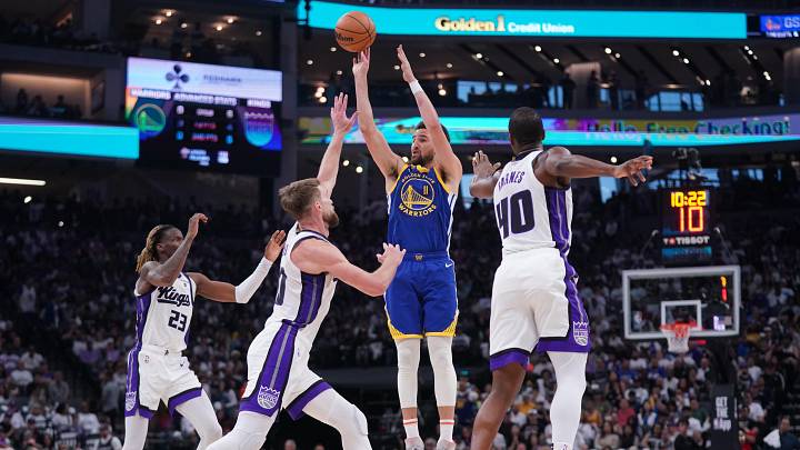 Apr 16, 2024; Sacramento, California, USA; Golden State Warriors guard Klay Thompson (11) shoots over Sacramento Kings guard Keon Ellis (23), forward Domantas Sabonis (10) and forward Harrison Barnes (40) in the second quarter during a play-in game of the 2024 NBA playoffs at the Golden 1 Center. Mandatory Credit: Cary Edmondson-USA TODAY Sports