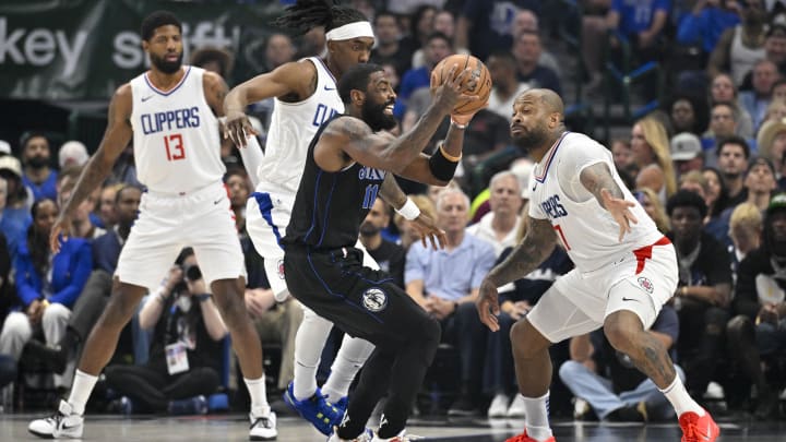  Dallas Mavericks guard Kyrie Irving (11) moves the ball past LA Clippers forward Paul George (13) and guard Terance Mann (14) and forward P.J. Tucker (17) during the first quarter during game six of the first round for the 2024 NBA playoffs at American Airlines Center. Mandatory Credit: