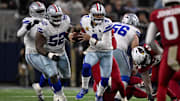 Dallas Cowboys quarterback Dak Prescott runs with the ball during the game between the Cowboys and the Arizona Cardinals.