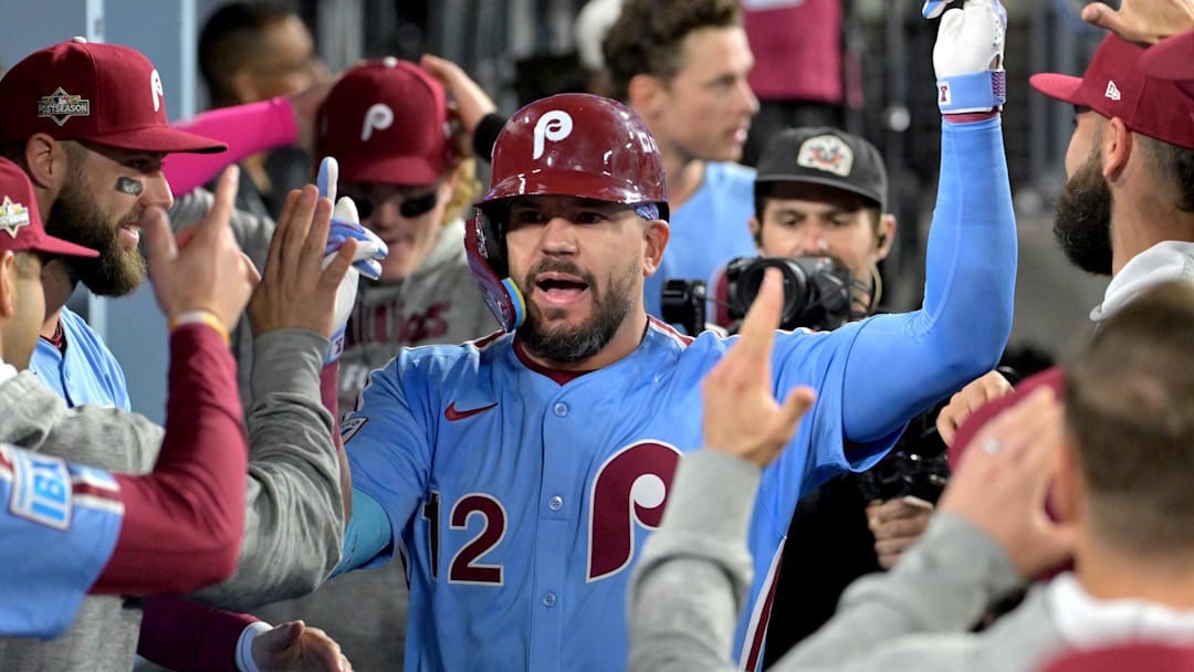 Oct 8, 2025; Los Angeles, California, USA; Philadelphia Phillies designated hitter Kyle Schwarber (12) congratulated in the dugout after hitting a solo home run in the fourth inning against the Los Angeles Dodgers of game three of the NLDS during the 2025 MLB playoffs at Dodger Stadium. Oct 8, 2025; Los Angeles, California, USA; Philadelphia Phillies designated hitter Kyle Schwarber (12) congratulated in the dugout after hitting a solo home run in the fourth inning against the Los Angeles Dodgers of game three of the NLDS during the 2025 MLB playoffs at Dodger Stadium.