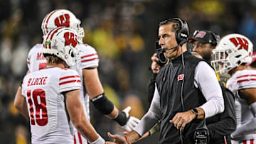 Nov 2, 2024; Iowa City, Iowa, USA; Wisconsin Badgers quarterback Braedyn Locke (18) reacts with head coach Luke Fickell during the fourth quarter against the Iowa Hawkeyes at Kinnick Stadium. Mandatory Credit: Jeffrey Becker-Imagn Images
