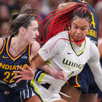 Indiana Fever guard Caitlin Clark (22) rushes up the court against Dallas Wings forward Satou Sabally (0) on Sunday, Sept. 15, 2024, during the game at Gainbridge Fieldhouse in Indianapolis. The Indiana Fever defeated the Dallas Wings, 110-109.