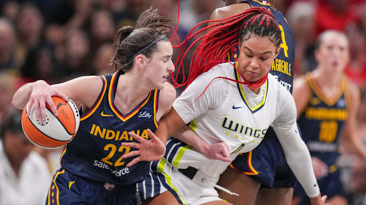 Indiana Fever guard Caitlin Clark (22) rushes up the court against Dallas Wings forward Satou Sabally (0) on Sunday, Sept. 15, 2024, during the game at Gainbridge Fieldhouse in Indianapolis. The Indiana Fever defeated the Dallas Wings, 110-109.