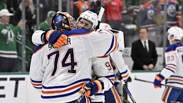 Edmonton Oilers goaltender Stuart Skinner (74) reacts with right wing Corey Perry (90) after defeating the Dallas Stars in game five of the Western Conference Final
