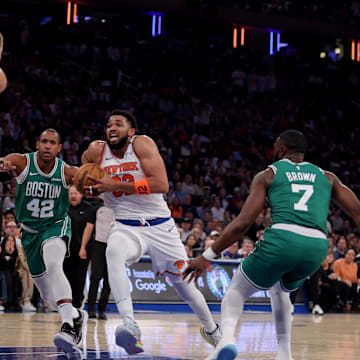 May 16, 2025; New York, New York, USA; New York Knicks center Karl-Anthony Towns (32) drives to the basket against Boston Celtics centers Kristaps Porzingis (8) and Al Horford (42) and guards Jaylen Brown (7) and Derrick White (9) during the first quarter of game six in the second round of the 2025 NBA Playoffs at Madison Square Garden. Mandatory Credit: Brad Penner-Imagn Images