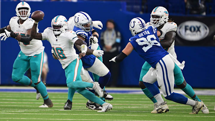 Miami Dolphins quarterback Tyler Huntley (18) runs through a few Indianapolis Colts during the second quarter at Lucas Oil Stadium. Miami Dolphins quarterback Tyler Huntley (18) runs through a few Indianapolis Colts during the second quarter at Lucas Oil Stadium.