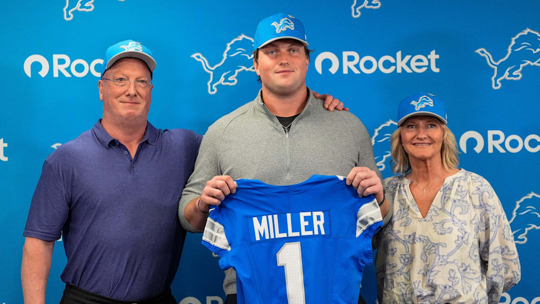 Detroit Lions first round draft Blake Miller, center, poses for a photo with his father Chris Miller, left, and mother Karen Miller at his introductory press conference at Meijer Performance Center in Allen Park on Friday, April 24, 2026.