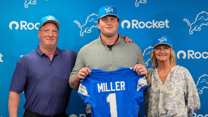 Detroit Lions first round draft Blake Miller, center, poses for a photo with his father Chris Miller, left, and mother Karen Miller at his introductory press conference at Meijer Performance Center in Allen Park on Friday, April 24, 2026.