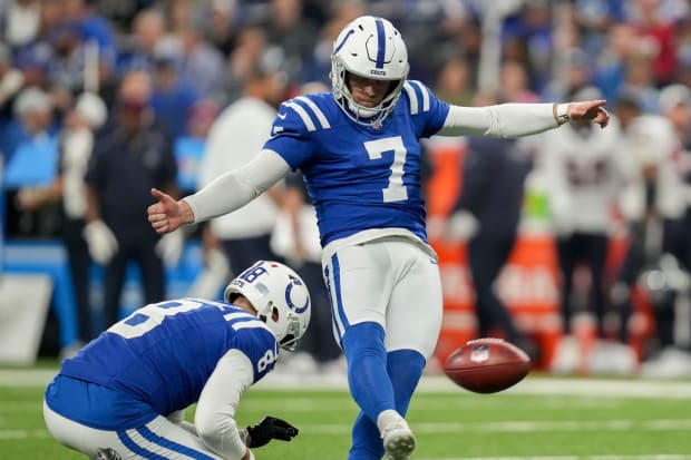 Football player Matt Gay kicks a field goal in a blue jersey.