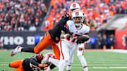 Cleveland Browns quarterback Dorian Thompson-Robinson (17) fumbles the ball as he is wrapped up by Cincinnati Bengals defensive end Joseph Ossai (58) in the fourth quarter of the NFL Week 16 game between the Cincinnati Bengals and the Cleveland Browns.