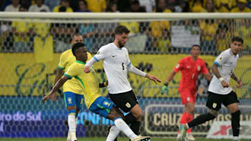 Rodrigo Bentancur on the ball under pressure from Vinicius Jr 