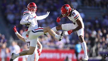 Nov 23, 2024; Fort Worth, Texas, USA; Arizona Wildcats defensive back Jack Luttrell (13) and defensive back Marquis Groves-Killebrew (20) celebrate an interception in the first quarter against the TCU Horned Frogs  at Amon G. Carter Stadium. Mandatory Credit: Tim Heitman-Imagn Images