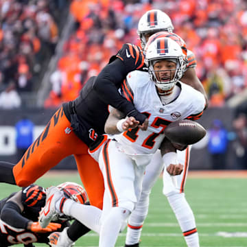 Cleveland Browns quarterback Dorian Thompson-Robinson (17) fumbles the ball as he is wrapped up by Cincinnati Bengals defensive end Joseph Ossai (58) in the fourth quarter of the NFL Week 16 game between the Cincinnati Bengals and the Cleveland Browns.