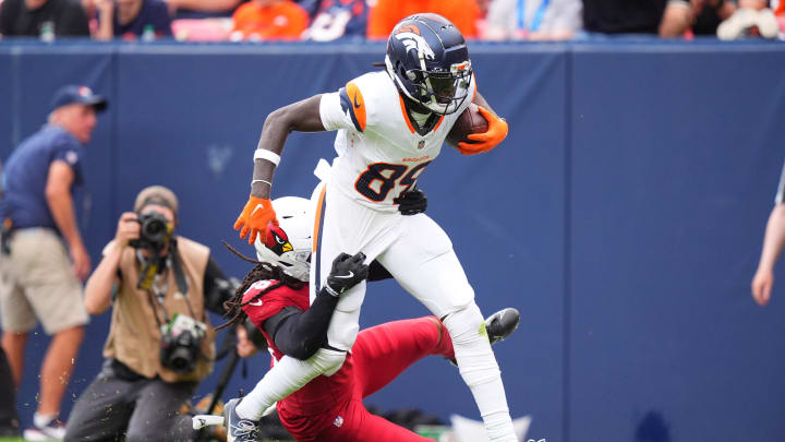 Aug 25, 2024; Denver, Colorado, USA; Arizona Cardinals safety Andre Chachere (36) tackles Denver Broncos wide receiver Brandon Johnson (89) in the second half at Empower Field at Mile High. Mandatory Credit: Ron Chenoy-USA TODAY Sports