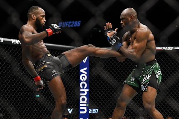 Leon Edwards (red gloves) fights Kamaru Usman (blue gloves) during UFC 286 at O2 Arena.