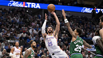 Oct 27, 2025; Dallas, Texas, USA; Oklahoma City Thunder guard Ajay Mitchell (25) shoots the ball over Dallas Mavericks forward P.J. Washington (25) during the second quarter at the American Airlines Center. Mandatory Credit: Jerome Miron-Imagn Images