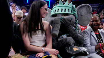 Indiana Fever's Caitlin Clark sits with New York Liberty mascot Ellie the Elephant ahead of the WNBA All-Star 3-point and skills contests 